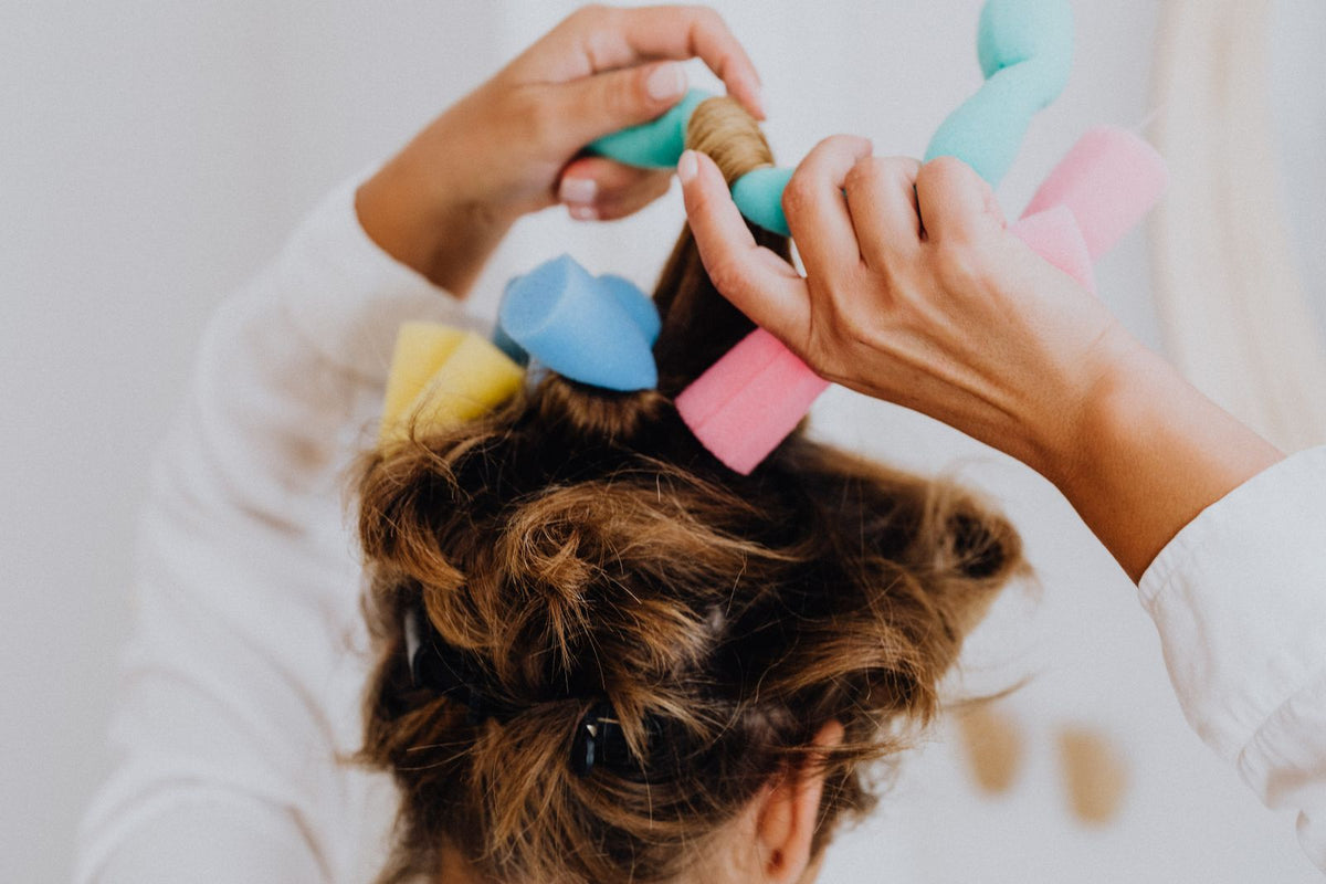 Close-up of hair being styled with soft curlers