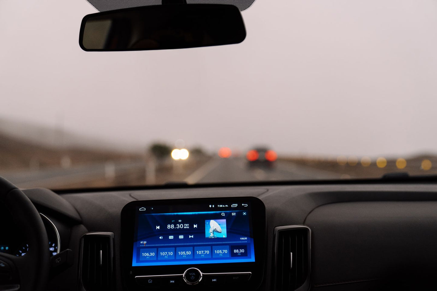 View of the road ahead from a car dashboard in daylight