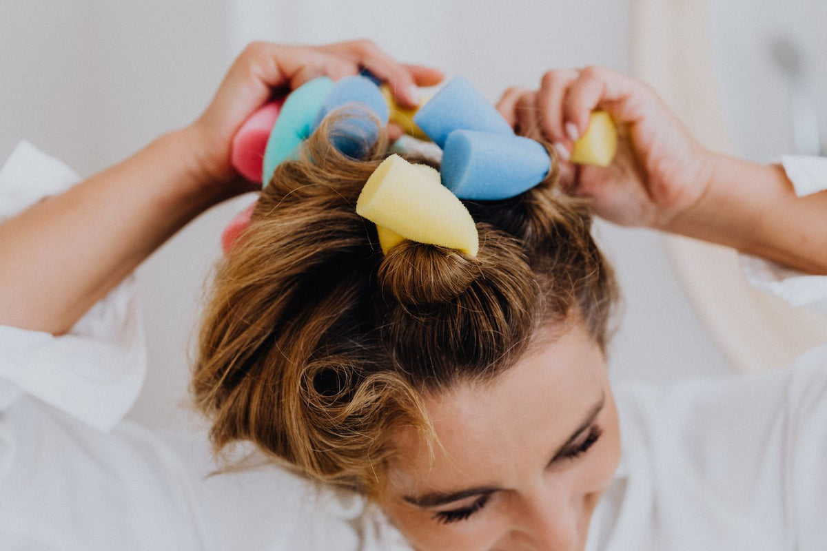 Woman setting her hair in curlers