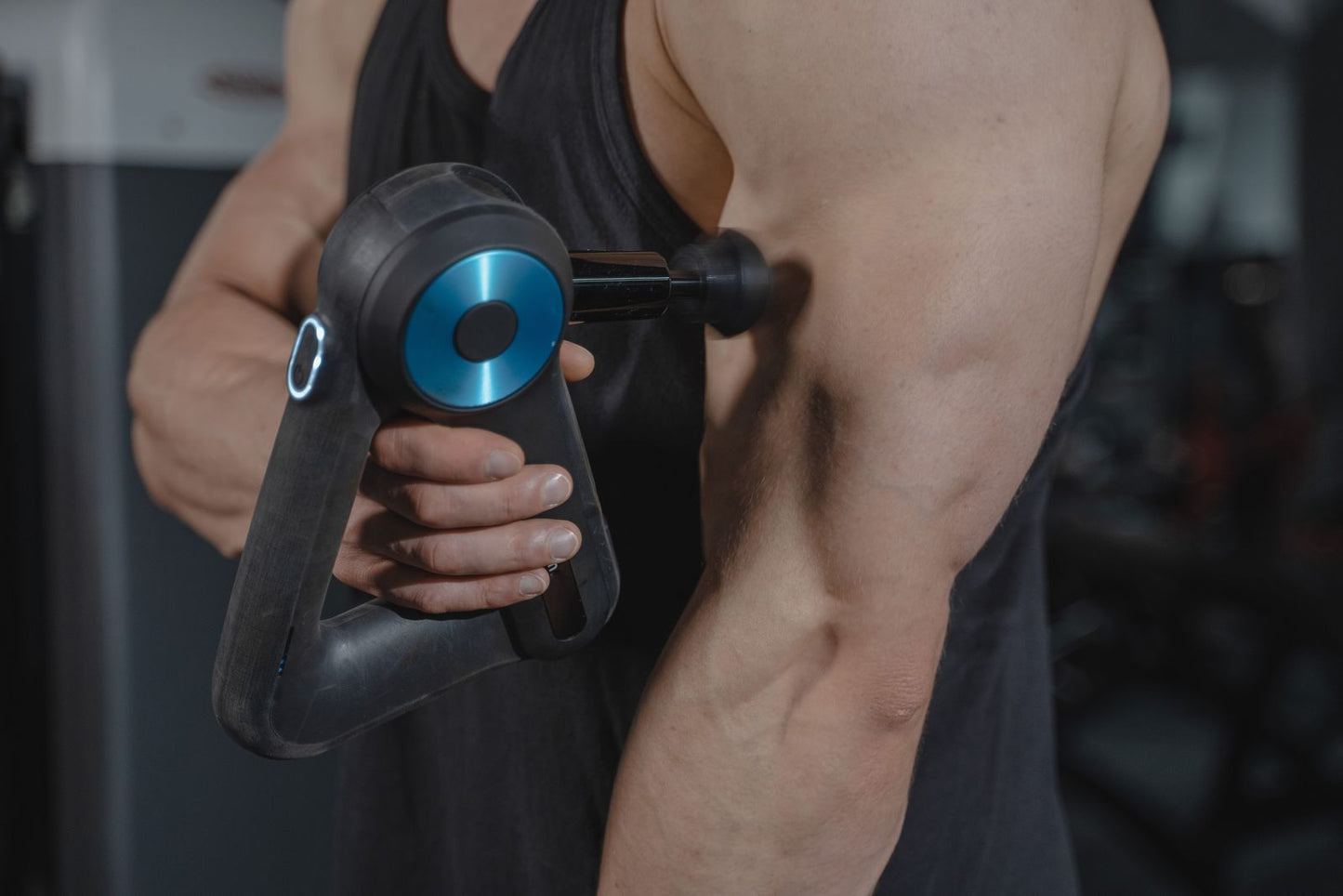 Massage gun applied to a leg muscle