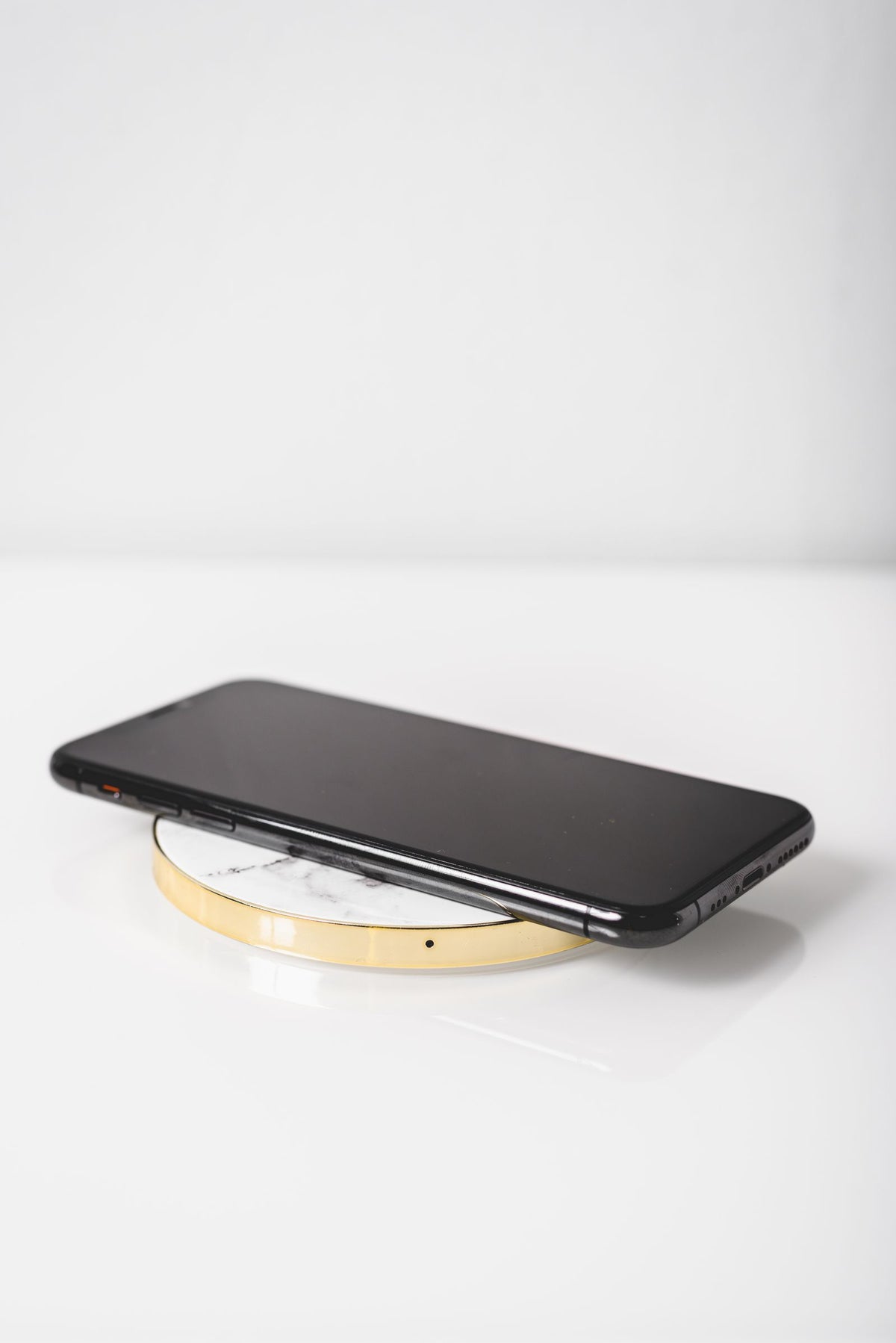 Black smartphone on a wireless charger