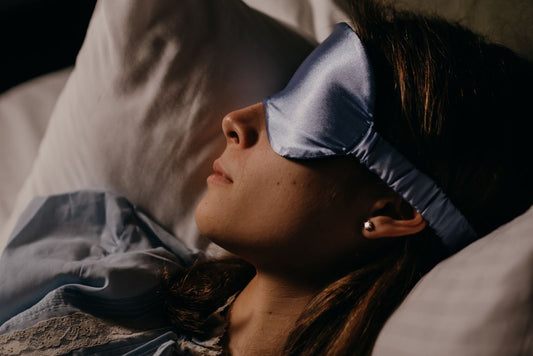 Person sleeping wearing a silk eye mask