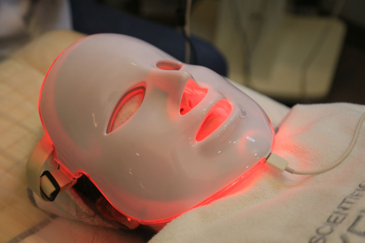 Close-up of a person wearing an LED light therapy face mask