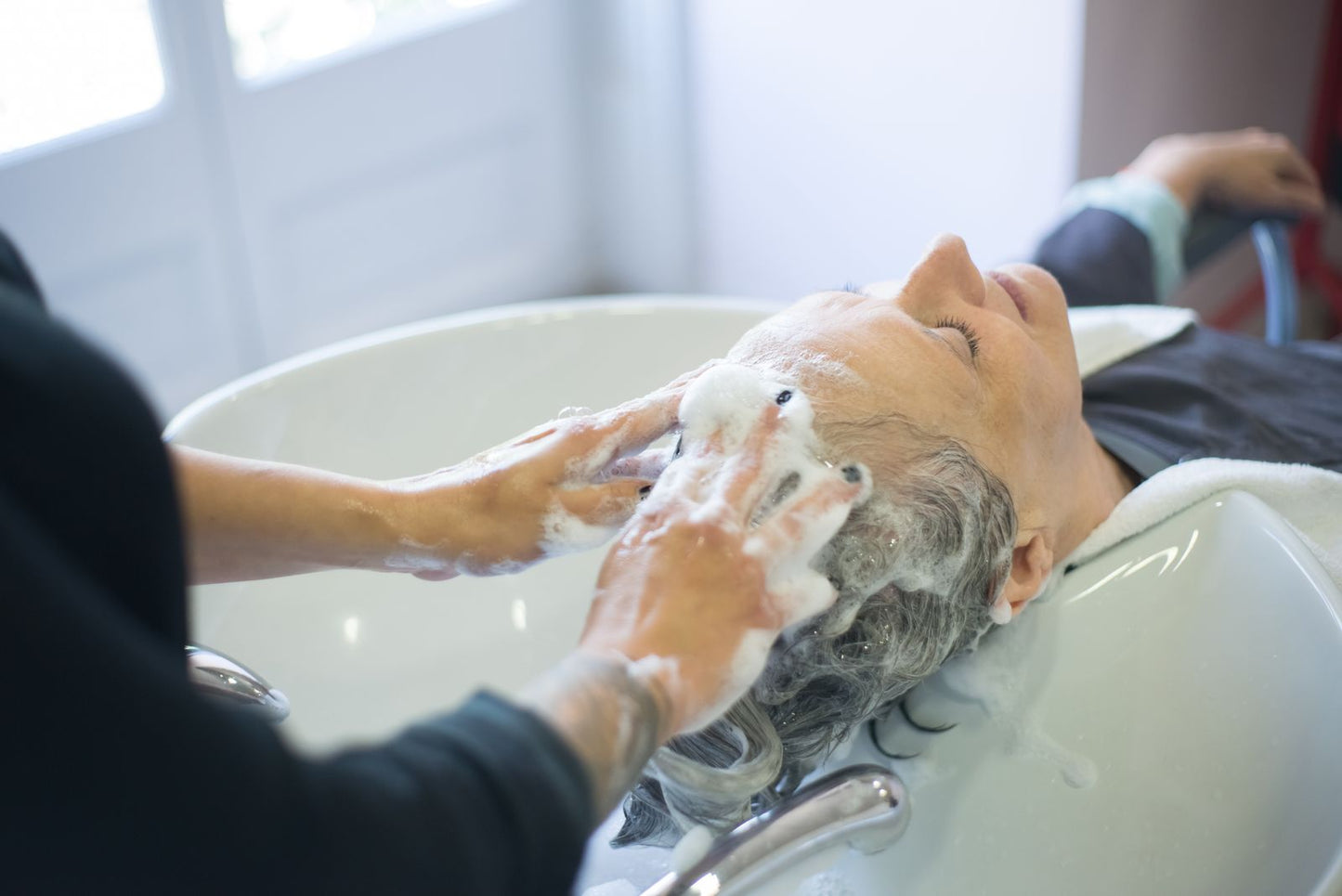 Scalp being washed and massaged at a salon